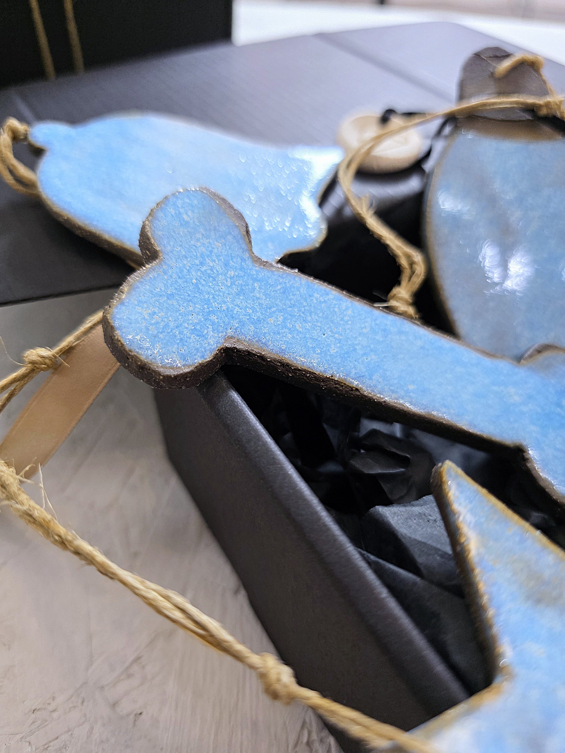 Box 2: Handcrafted ceramic fish and cross ornaments with twine, presented in a luxury tissue-lined gift box—ideal for Christmas gifting.