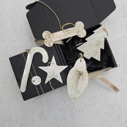 Box 7 features cream-colored, textured ceramic ornaments in festive shapes, presented in a handcrafted gift box with tan ribbon. Perfect for Christmas gifting, these elegant accents enhance any holiday décor.