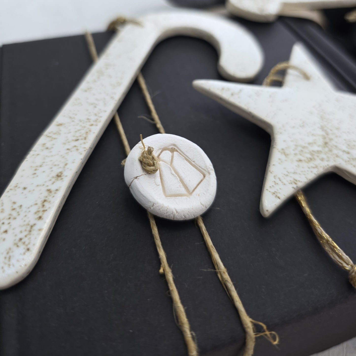 Box 7 features handmade white clay ornaments—a candy cane, star, and gift tag—each with rustic speckling and twine ties. Perfect for Christmas gifting, these charming pieces add a handcrafted touch to any present or festive gift box.