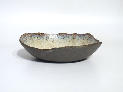 The STONE BIG SALAD BOWL is a handmade ceramic piece, 27.5 cm in diameter, with a rough dark exterior and smooth light interior, shown against a plain white background.