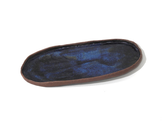 Oval ceramic tray with blue interior and brown made of red stoneware