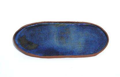 Oval ceramic tray with blue interior and brown made of red stoneware