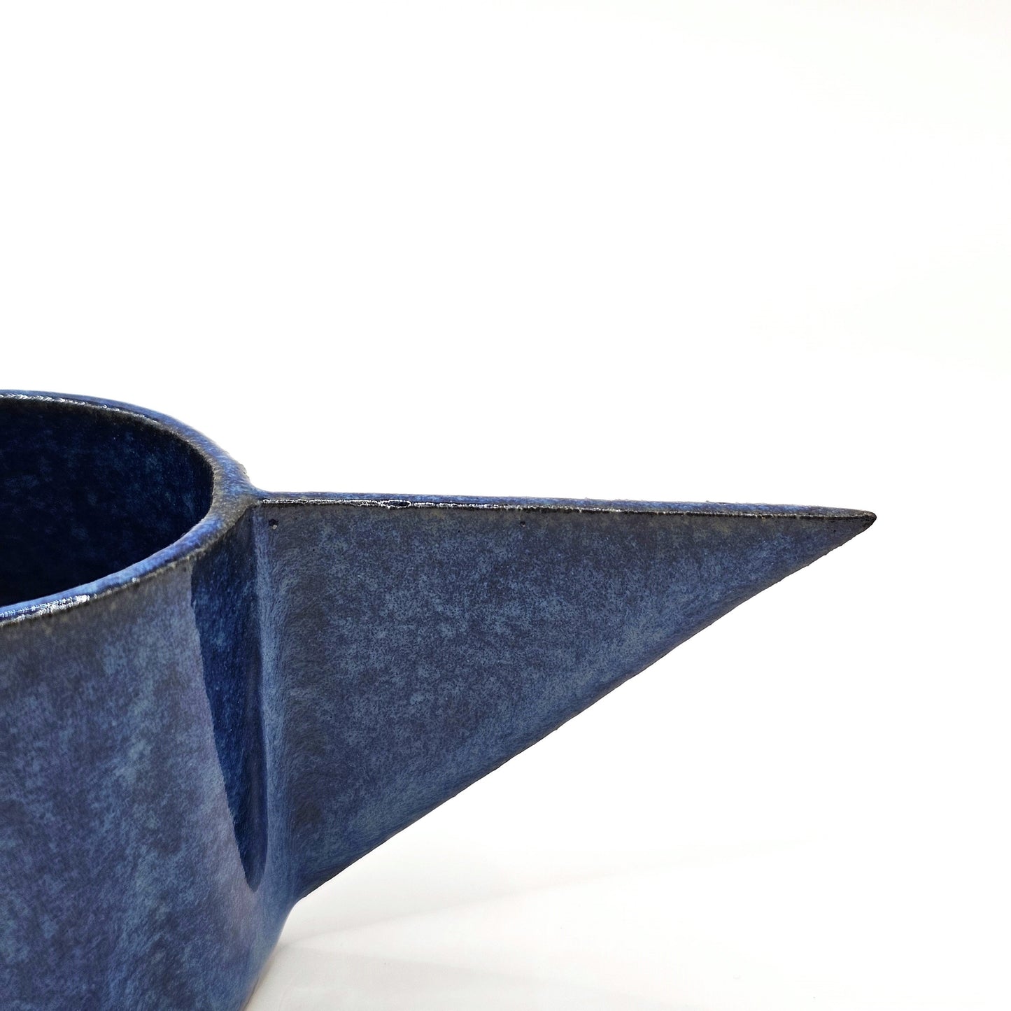 handmade Blue ceramic teapot with a pointed handle 