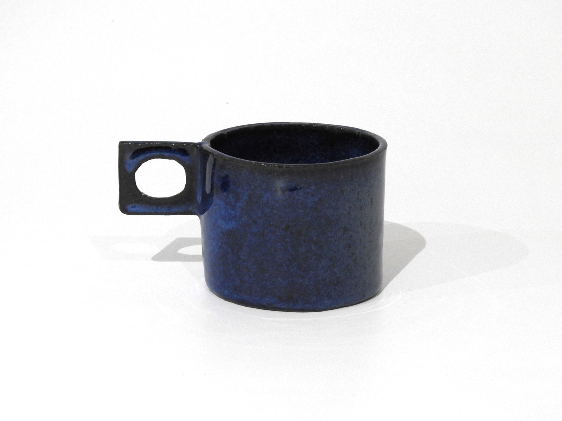 handmade ceramic mug with square handle

unique blue ceramic cappuccino cup

modern artisan pottery coffee mug

handcrafted stoneware espresso cup

minimalist handmade ceramic tea cup