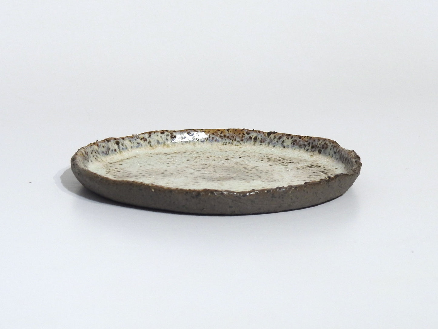 Ceramic plate with a textured surface on a white background