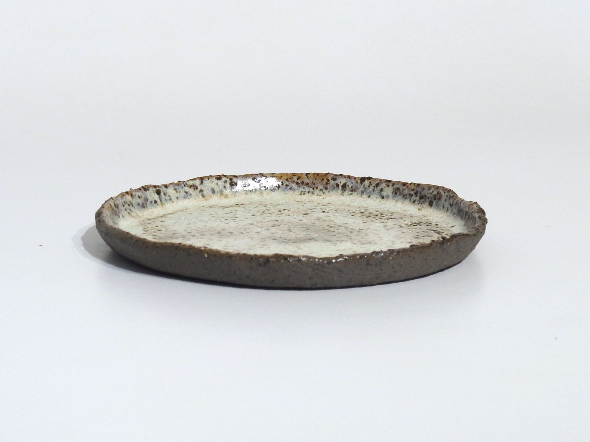 Ceramic plate with a textured surface on a white background
