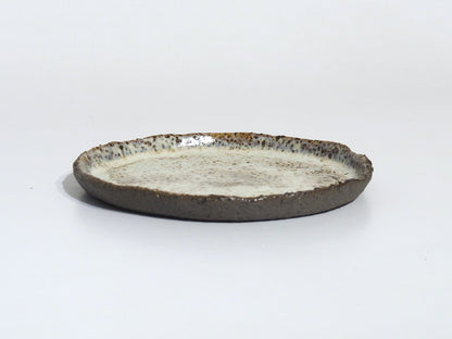 Ceramic plate with a textured surface on a white background