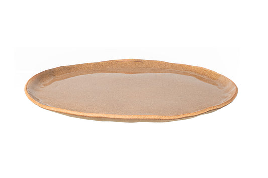 The SAND PLATE is a handmade, round stoneware plate with a slightly uneven rim and glossy beige glaze, shown against a white background.