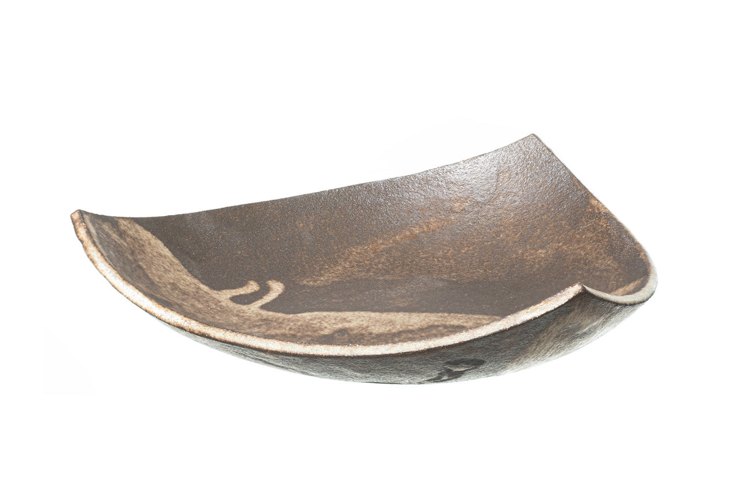 The SOIL TRIANGULAR PLATE is a handcrafted ceramic plate featuring an asymmetrical, textured brown surface and uneven curved edges, exemplifying Greek craftsmanship against a white background.