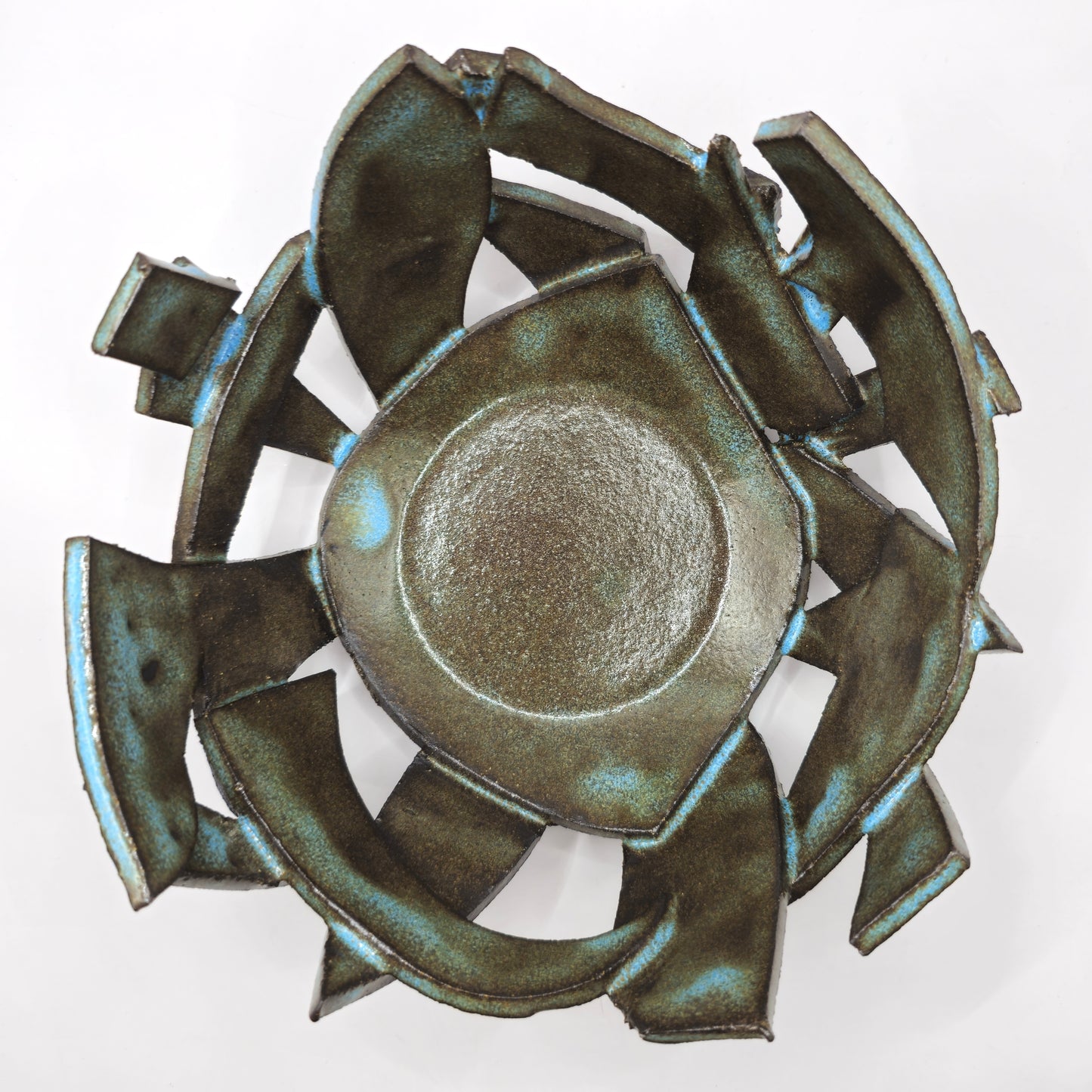 The ATLANTIS 'BRUTE' BOWL is a metallic, abstract geometric bowl crafted from handmade stoneware with jagged edges and a glossy, textured green and blue surface, shown on a white background.