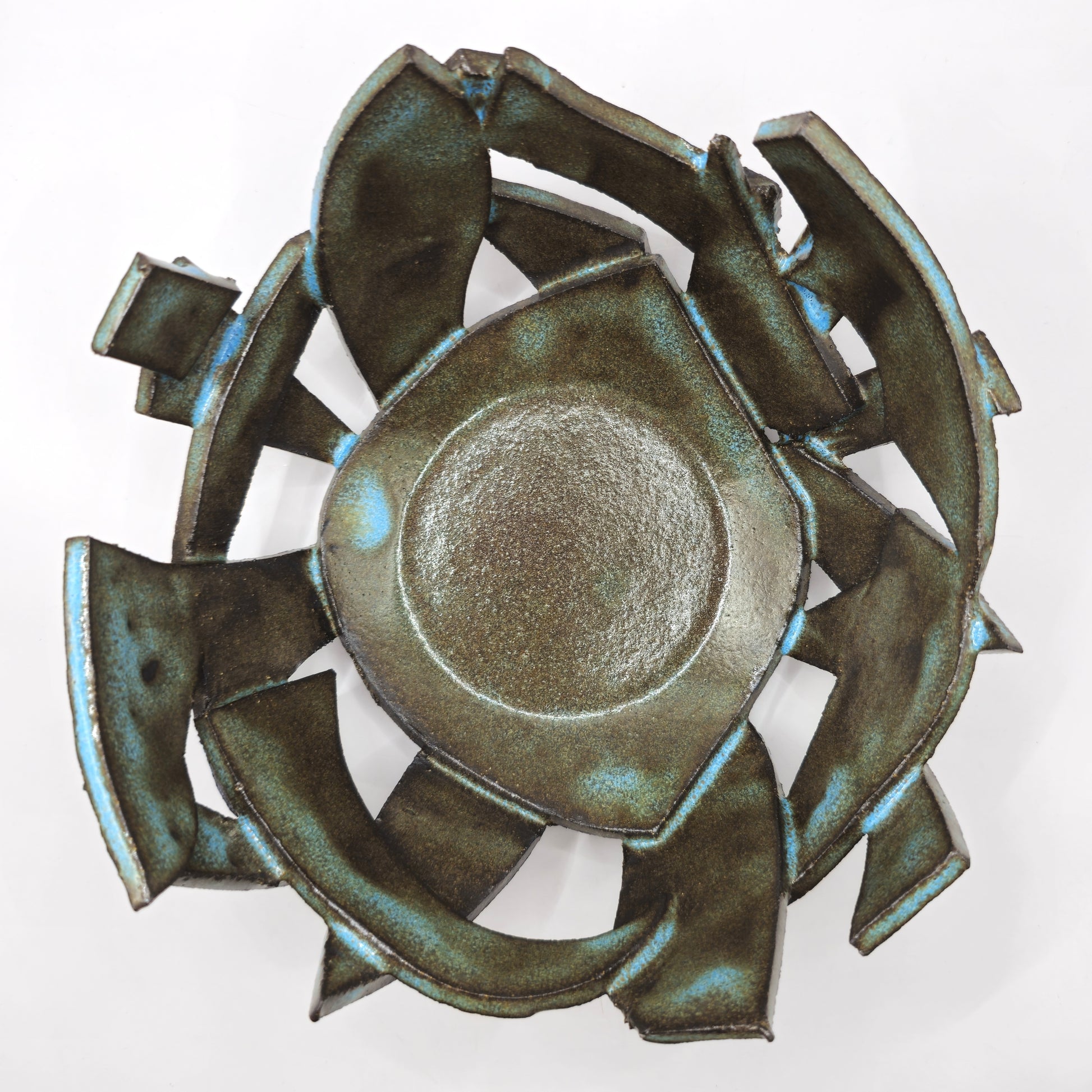 The ATLANTIS 'BRUTE' BOWL is a metallic, abstract geometric bowl crafted from handmade stoneware with jagged edges and a glossy, textured green and blue surface, shown on a white background.