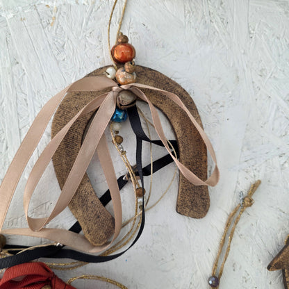 Decorative item with ribbons and beads on a textured white surface