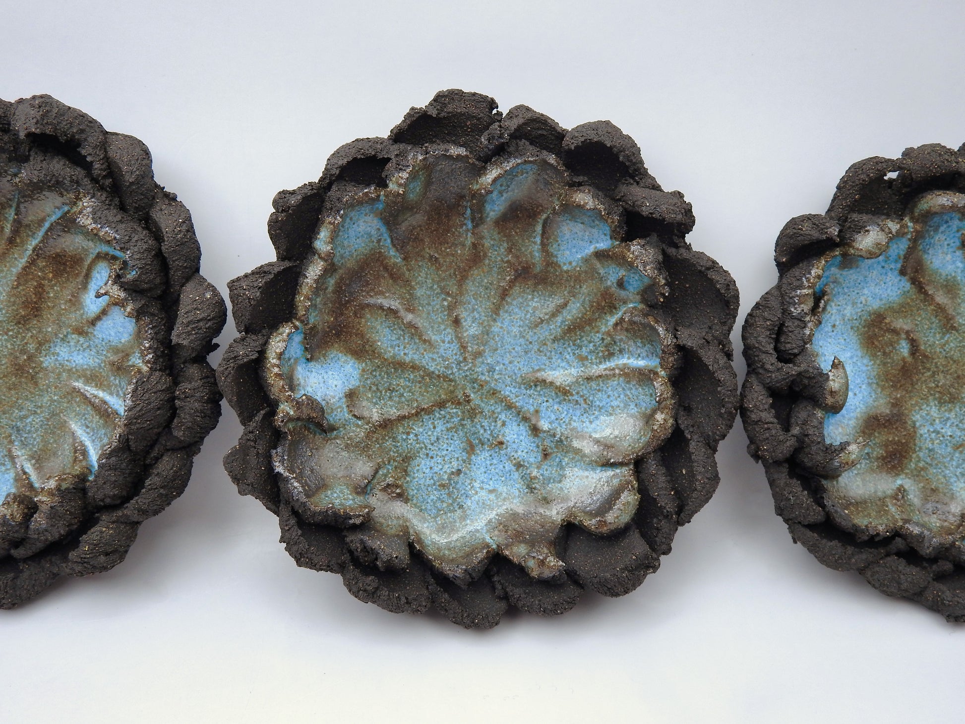  ceramic gift for smokers with textured surfaces and blue-green glaze on black clay