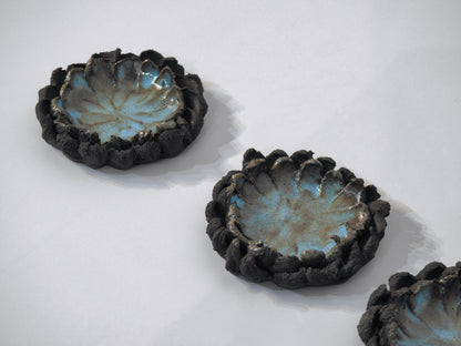 ashtray ceramic bowls with textured black exteriors and blue interior glaze on a cigarette holder
