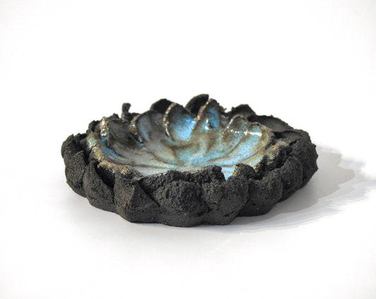 Ceramic bowl with textured black exterior and blue interior ashtray
