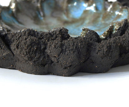 Ceramic bowl with textured black exterior and blue interior ashtray